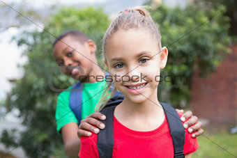 Cute pupils smiling at camera outside