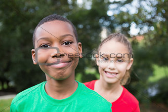 Cute children smiling at camera outside