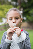 Cute little girl blowing dandelion