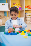 Cute little boy playing with building blocks