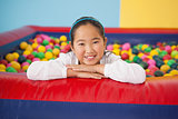 Happy girl playing in ball pool