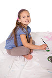 Happy little girl painting on the floor