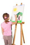 Happy little girl painting on easel