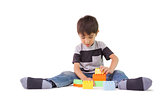 Happy little boy playing with building blocks