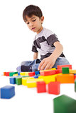 Happy little boy playing with building blocks