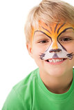 Happy little boy in tiger face paint