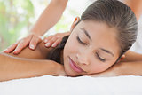 Beautiful brunette enjoying a massage