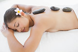 Beautiful brunette enjoying a hot stone massage