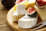 cheeseboard with maasdam, camembert, cheddar cheese and figs