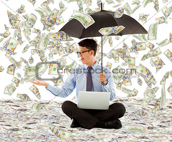 young business man holding a umbrella with dollar rain