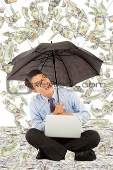 happy business man sitting on floor with us dollar rain