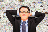 business man enjoying and lying on the money