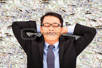 business man enjoying and lying on the money