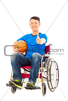 asia young man sitting on a wheelchair and thumb up