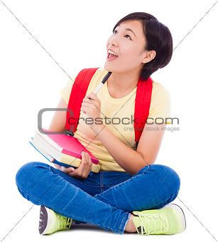 young student girl sitting on floor with book