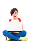 Smiling young student girl sitting with a laptop