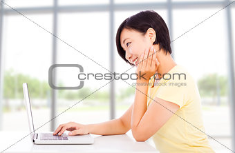 tired student in front of a laptop at home or classroom 
