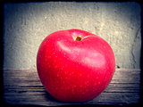 Red apple on wooden table