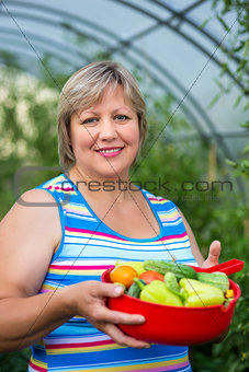 Woman with vegetables in a greenhouse