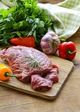 Raw beef steak with ingredients vegetables on a wooden board