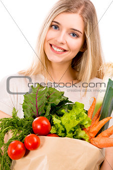 Beautiful woman carrying vegetables