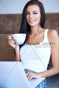 Young woman enjoying a cup of espresso coffee