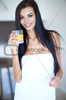 Healthy young woman drinking fresh orange juice