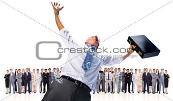 Composite image of businessman holding briefcase and cheering