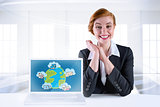 Composite image of excited redhead businesswoman sitting at desk