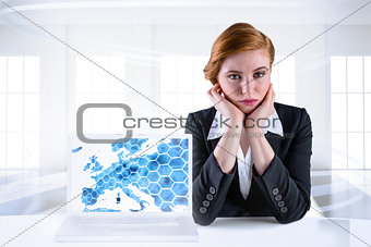Composite image of redhead businesswoman looking unhappy