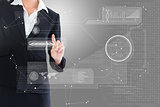 Composite image of businesswoman pointing  at interface