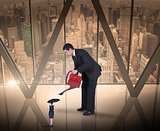 Composite image of businessman watering tiny business woman