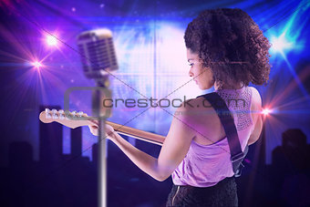 Composite image of pretty girl playing guitar