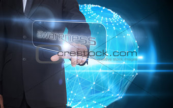 Businessman pointing to word awareness