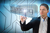 Businessman pointing to word planning