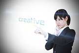 Businesswoman pointing to word creative