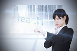 Businesswoman pointing to word reach