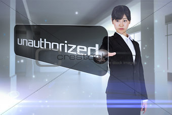 Businesswoman pointing to word unauthorized