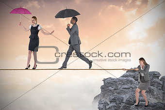 Young business woman pulling a tightrope for business people