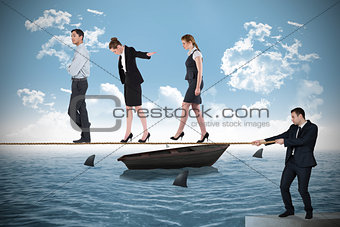 Young businessman pulling a tightrope for business people