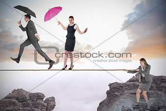 Young businesswoman pulling a tightrope for business people