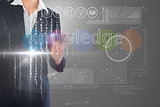 Businesswoman touching the word knowledge on interface