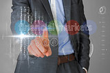 Businessman touching the words financial markets on interface