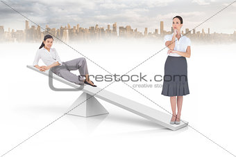 White scales weighing two businesswomen