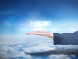 Businesswomans hand presenting the word e learning