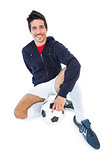 Football player sitting with ball