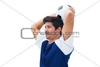 Football player in white throwing ball