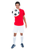Football player in red showing ball