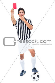 Serious referee showing red card