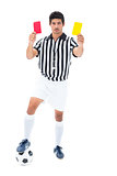 Serious referee showing red and yellow card